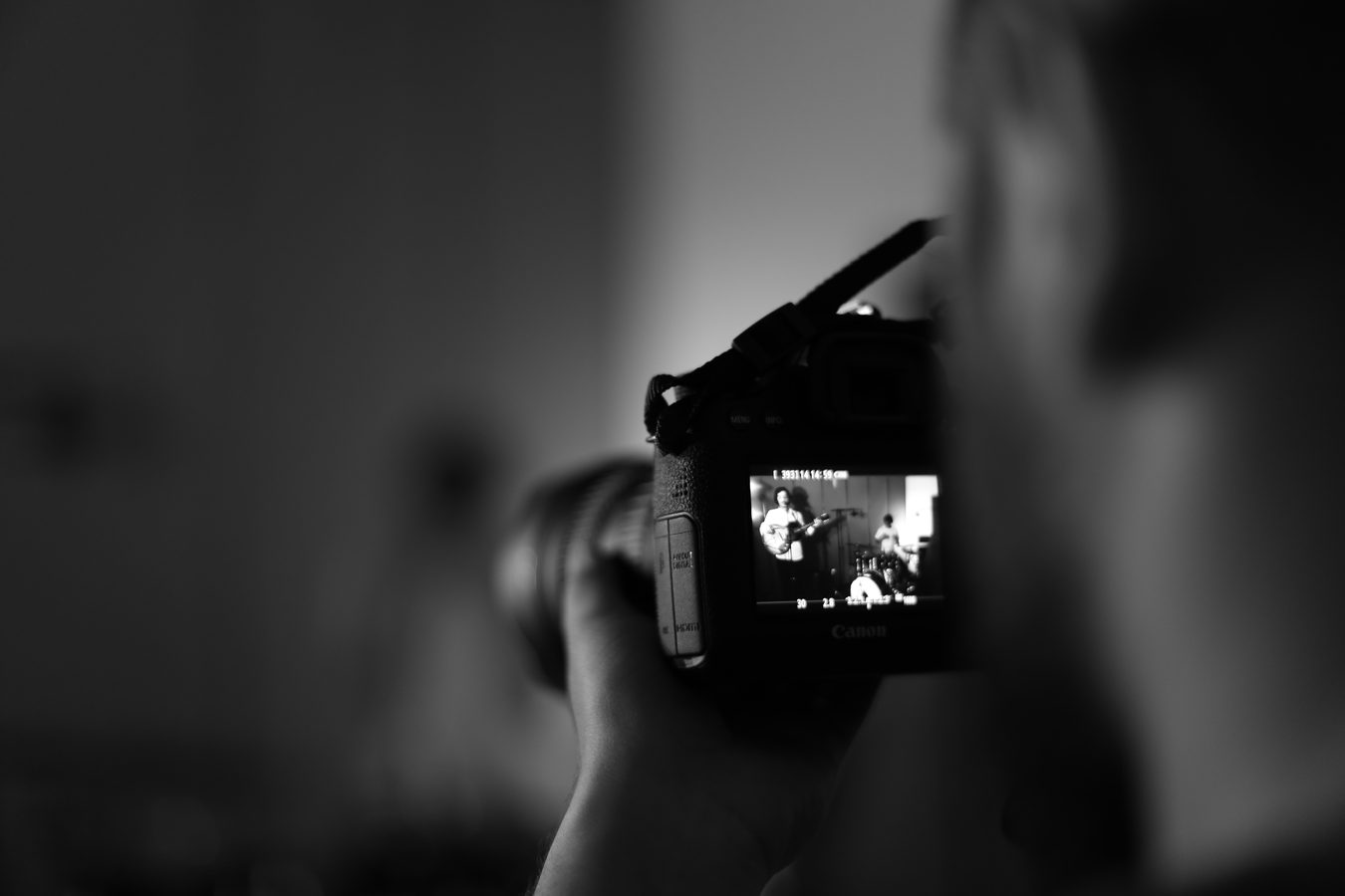 A camera screen framing the band.